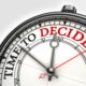 time to decide concept clock closeup on white background with red and black words